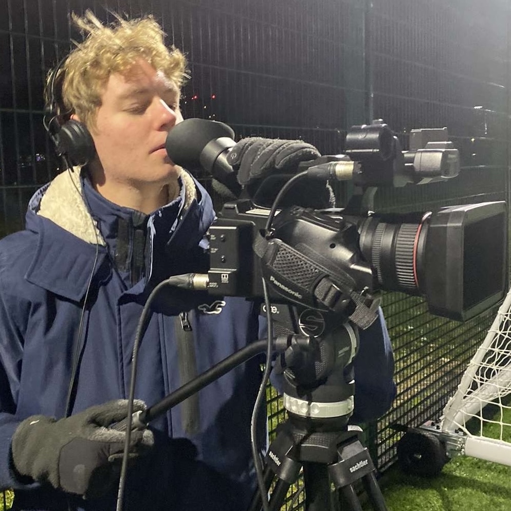 Thomas filming with a broadcast camrea