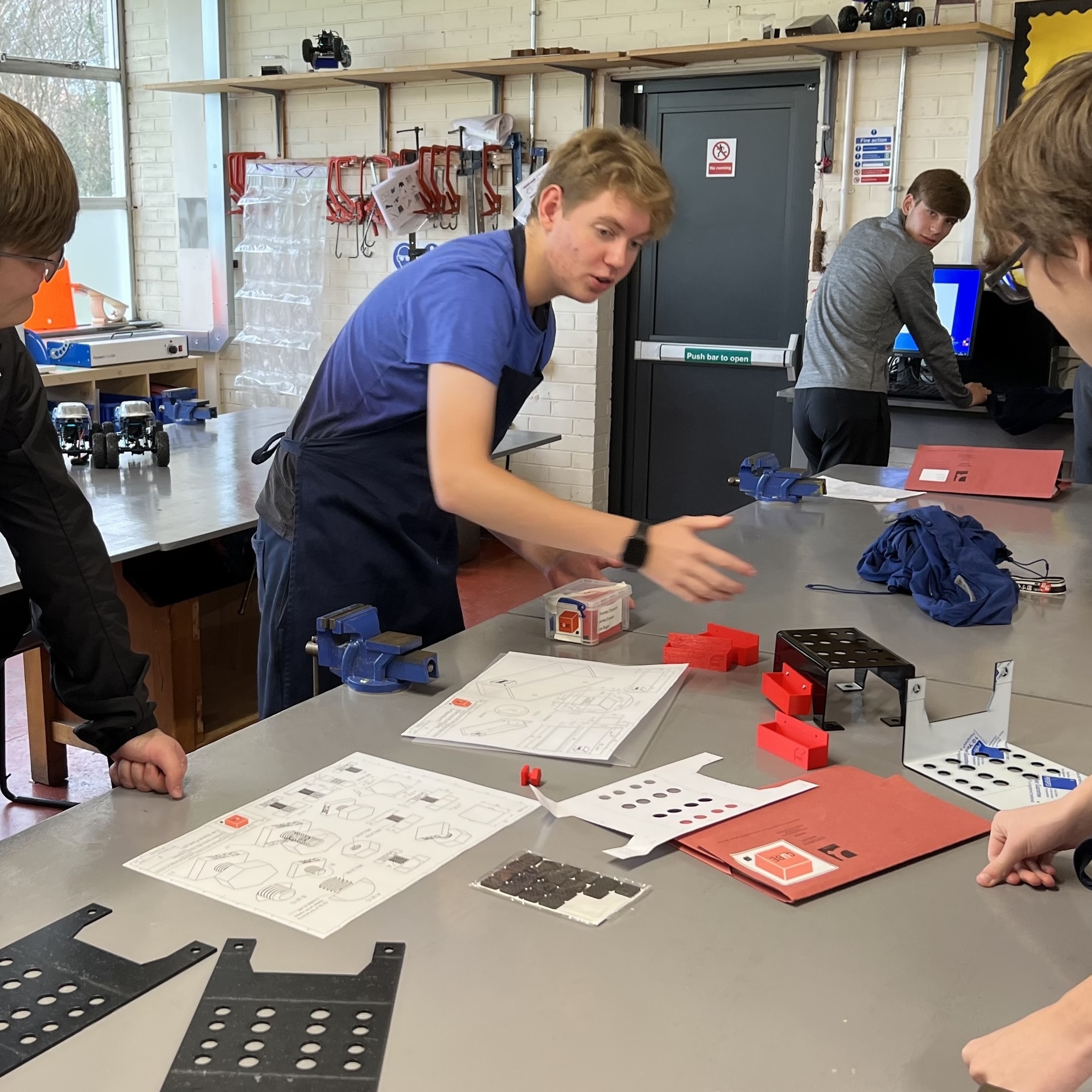 Thomas discusing a project in a workshop