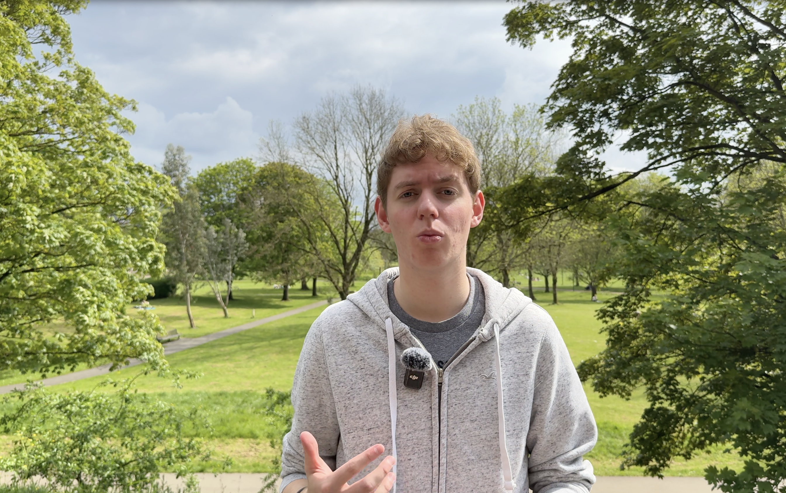 Thomas in a park presenting a informational video
