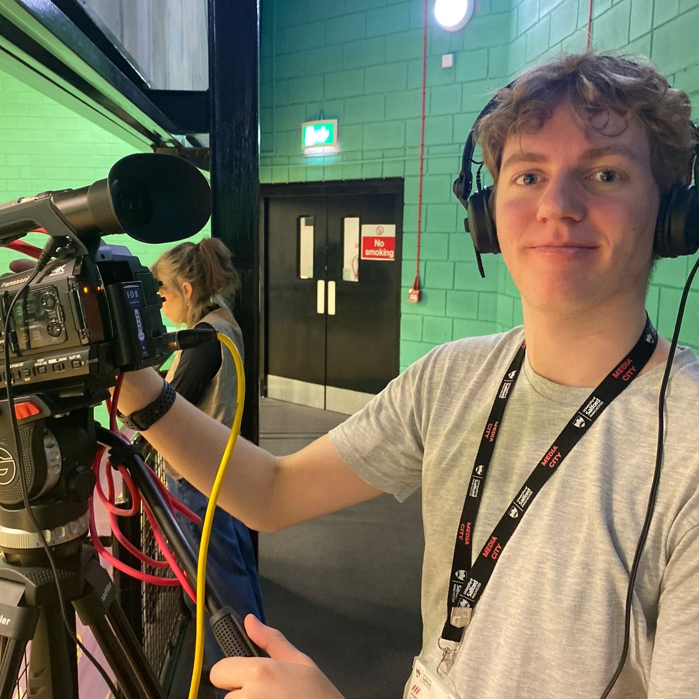 Thomas filming with a broadcast camrea